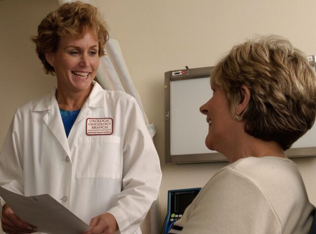 A doctor talking with a patient during a medical consultation.